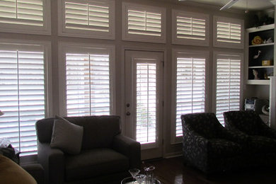 Family room - huge contemporary light wood floor family room idea in Austin with beige walls, a standard fireplace and a wood fireplace surround