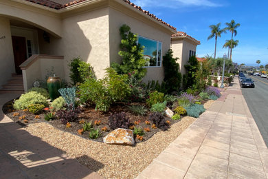 Design ideas for a small mediterranean drought-tolerant and partial sun front yard gravel landscaping in San Diego.