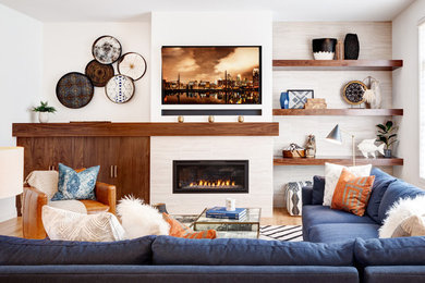 Inspiration for a large transitional open concept living room in Minneapolis with white walls, medium hardwood floors, a ribbon fireplace, a tile fireplace surround and a wall-mounted tv.