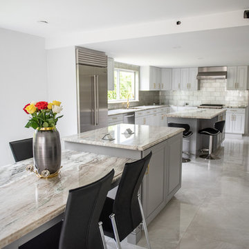 Transitional Kitchen Done in a 2 Tone Color With Integrated Dining Table