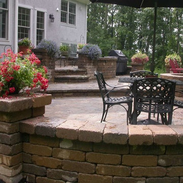 Terraced brick patio with courtyard walls and firepit