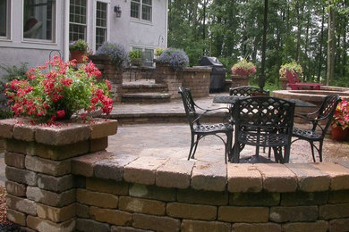 Inspiration for a large craftsman backyard brick patio remodel in Columbus with a fire pit