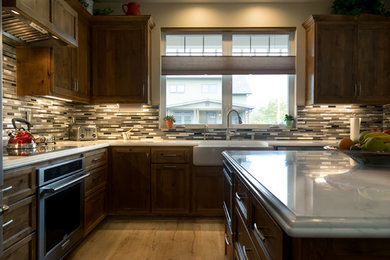 Kitchen - transitional medium tone wood floor kitchen idea in San Luis Obispo with marble countertops, multicolored backsplash and an island