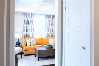 Example of a large transitional enclosed dark wood floor and brown floor living room design in Toronto with gray walls, no fireplace and a wall-mounted tv