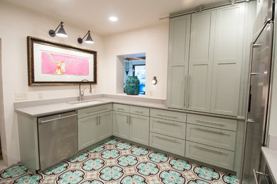 Example of a mid-sized tuscan cement tile floor enclosed kitchen design in Austin with a single-bowl sink, shaker cabinets, quartz countertops, green cabinets, beige backsplash, stainless steel appliances and no island