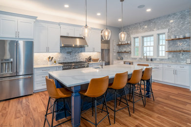 Example of a trendy kitchen design in Philadelphia with shaker cabinets and an island