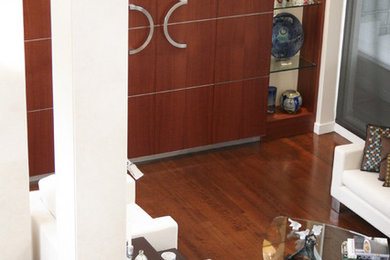 Example of a large minimalist medium tone wood floor great room design in Montreal with white walls