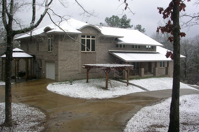 Inspiration for a large rustic gray three-story brick exterior home remodel in Birmingham