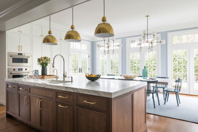 Example of a huge transitional brown floor eat-in kitchen design in New York with a drop-in sink, recessed-panel cabinets, brown cabinets, marble countertops, an island and white countertops