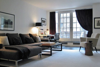Example of a large trendy open concept dark wood floor living room design in Other with white walls, a wall-mounted tv and no fireplace