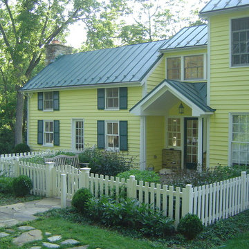 Fenced-in front yard with stone walkway and benches