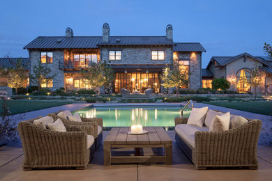Example of a large tuscan multicolored two-story stone exterior home design in Sacramento with a metal roof