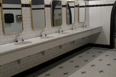 Bathroom - traditional black and white tile and ceramic tile porcelain tile bathroom idea in Detroit with a wall-mount toilet, quartzite countertops and white countertops