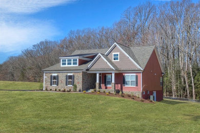 Inspiration for a country red mixed siding exterior home remodel in DC Metro with a shingle roof
