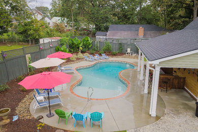Design ideas for a mid-sized backyard custom-shaped natural pool in Other.