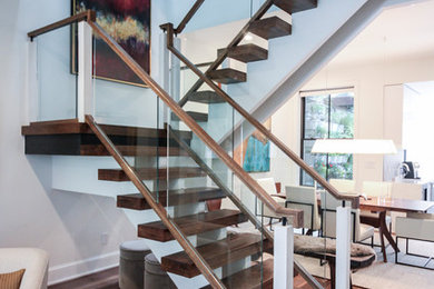 Huge trendy glass floating open and glass railing staircase photo in DC Metro