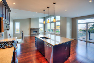 Eat-in kitchen - mid-sized modern l-shaped medium tone wood floor eat-in kitchen idea in Other with an undermount sink, shaker cabinets, dark wood cabinets, quartzite countertops, brown backsplash, ceramic backsplash, stainless steel appliances and an island