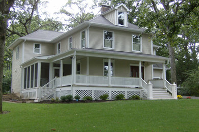 Inspiration for a mid-sized timeless beige two-story vinyl exterior home remodel in St Louis