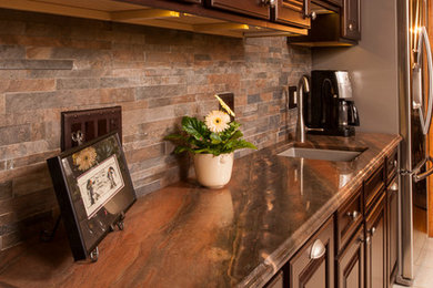Inspiration for a small transitional single-wall ceramic tile eat-in kitchen remodel in Detroit with a single-bowl sink, raised-panel cabinets, dark wood cabinets, multicolored backsplash, ceramic backsplash, stainless steel appliances and a peninsula