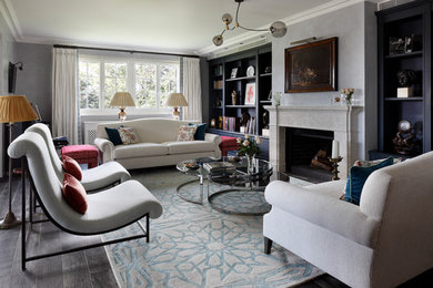 This is an example of an eclectic formal living room in London with grey walls, dark hardwood floors, a standard fireplace, a stone fireplace surround and brown floor.