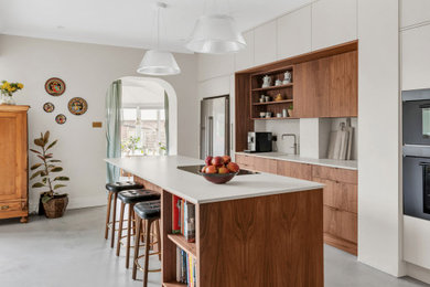 This is an example of a large modern kitchen in London with with island and grey floor.