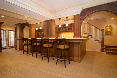 Large elegant single-wall carpeted seated home bar photo in Chicago with glass-front cabinets and dark wood cabinets