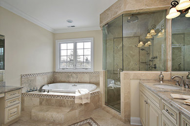 Design ideas for a large traditional master bathroom in Tampa with raised-panel cabinets, white cabinets, a drop-in tub, a corner shower, beige walls, an undermount sink, granite benchtops, porcelain tile, ceramic floors, beige floor and a hinged shower door.