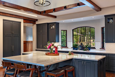 Mountain style galley dark wood floor, brown floor and exposed beam kitchen photo in Phoenix with an undermount sink, shaker cabinets, blue cabinets, white backsplash, subway tile backsplash, an island and white countertops