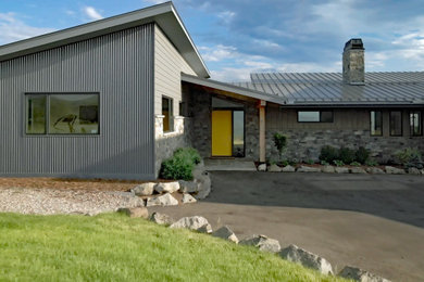 Example of a mid-sized trendy gray two-story mixed siding house exterior design in Denver with a shed roof, a metal roof and a gray roof