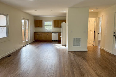 Family room - mid-sized 1950s open concept medium tone wood floor family room idea in Other with white walls, a standard fireplace and a brick fireplace