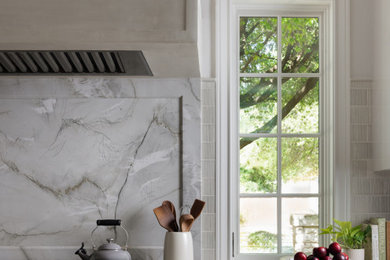 Inspiration for a timeless kitchen remodel in Austin with quartzite countertops, gray countertops, gray backsplash and an island