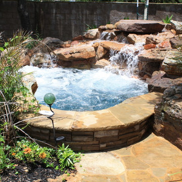 Spa with large rock waterfall