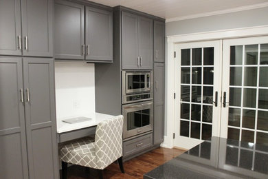 Large l-shaped dark wood floor open concept kitchen photo in Philadelphia with an undermount sink, shaker cabinets, gray cabinets, quartz countertops, white backsplash, subway tile backsplash, stainless steel appliances and an island