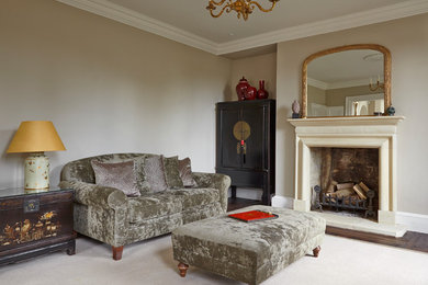 This is an example of a large country formal enclosed living room in Oxfordshire with a wood stove and a wood fireplace surround.