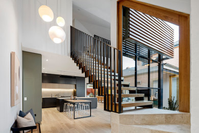 Contemporary wood straight staircase in Melbourne with metal railing.