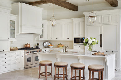 Large elegant l-shaped limestone floor open concept kitchen photo in Atlanta with raised-panel cabinets, white cabinets, white backsplash, subway tile backsplash, paneled appliances, an island, an undermount sink and granite countertops