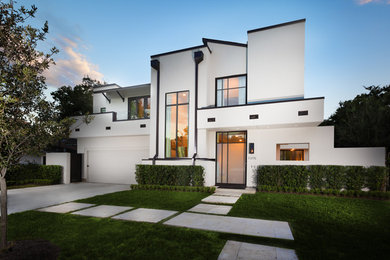Large transitional white two-story stucco flat roof idea in Houston
