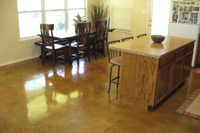 Inspiration for a mid-sized transitional concrete floor and brown floor kitchen/dining room combo remodel in Austin with beige walls and no fireplace