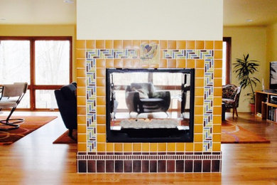 Example of a large arts and crafts open concept light wood floor living room design in Birmingham with beige walls, a two-sided fireplace and a tile fireplace