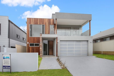 Mid-sized contemporary home design in Wollongong.