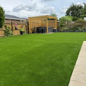 Artificial Lawn Looking Up to a Slatted Pergola
