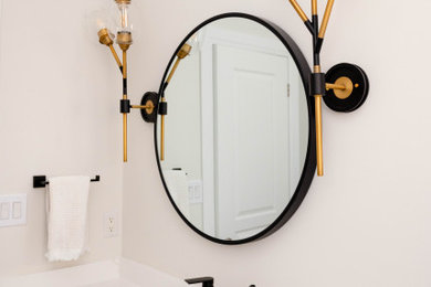 Example of a mid-sized danish porcelain tile and wallpaper powder room design in Toronto with shaker cabinets, white walls, an undermount sink, white countertops and a built-in vanity