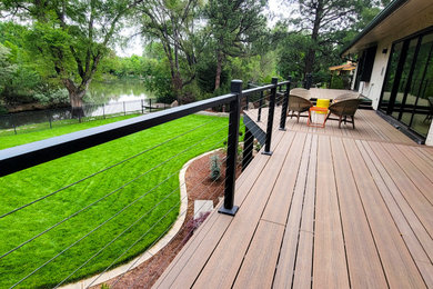 This is an example of a large mid-century modern backyard landscaping in Denver.