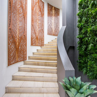 Design ideas for a large contemporary curved staircase in Sydney with limestone treads and limestone risers.