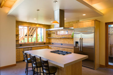 Inspiration for a mid-sized contemporary l-shaped concrete floor and gray floor eat-in kitchen remodel in San Francisco with an undermount sink, flat-panel cabinets, light wood cabinets, solid surface countertops, brown backsplash, stone tile backsplash, stainless steel appliances and an island