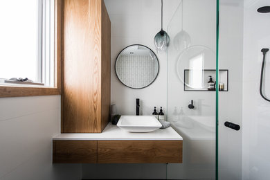 Mid-sized contemporary 3/4 bathroom in Melbourne with flat-panel cabinets, medium wood cabinets, a corner shower, white tile, ceramic tile, white walls, a vessel sink, engineered quartz benchtops and a hinged shower door.