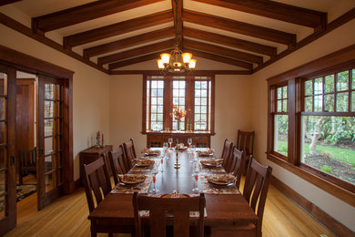 Example of a large classic medium tone wood floor enclosed dining room design in Seattle