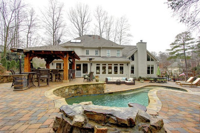 Inspiration for a large transitional gray three-story stucco exterior home remodel in Atlanta