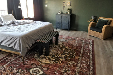 Inspiration for a mid-sized contemporary master laminate floor and beige floor bedroom remodel in Phoenix with green walls