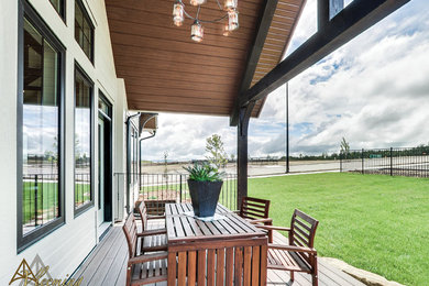 Cottage beige split-level mixed siding exterior home idea in Other with a shingle roof